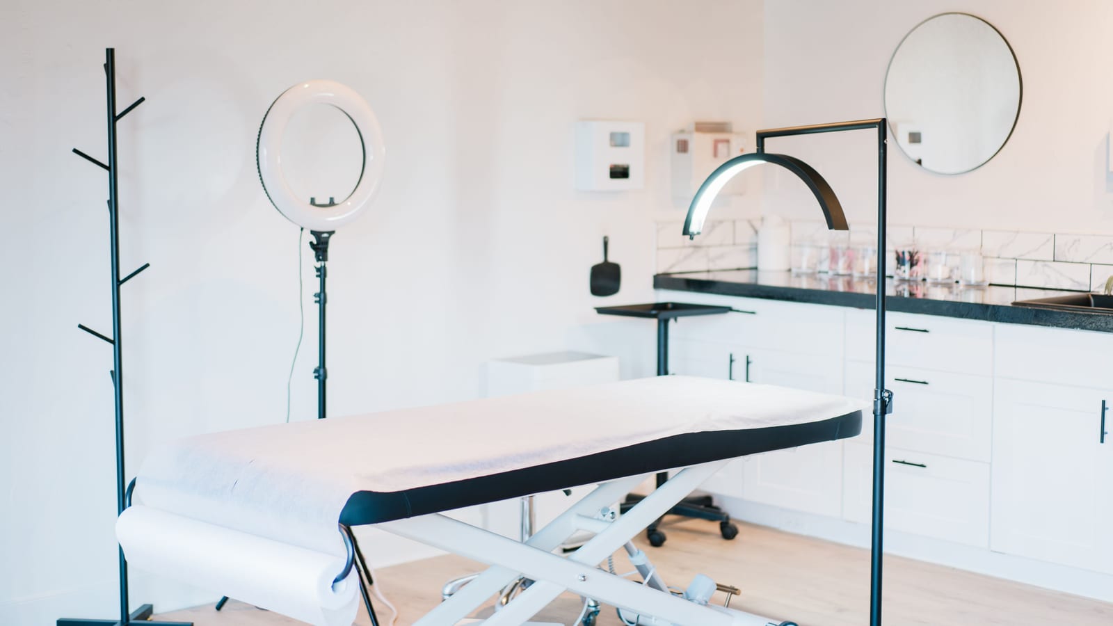 Serene med spa treatment room with a linen-draped bed and a large window — reducing stubborn belly fat at OC Weight Loss &