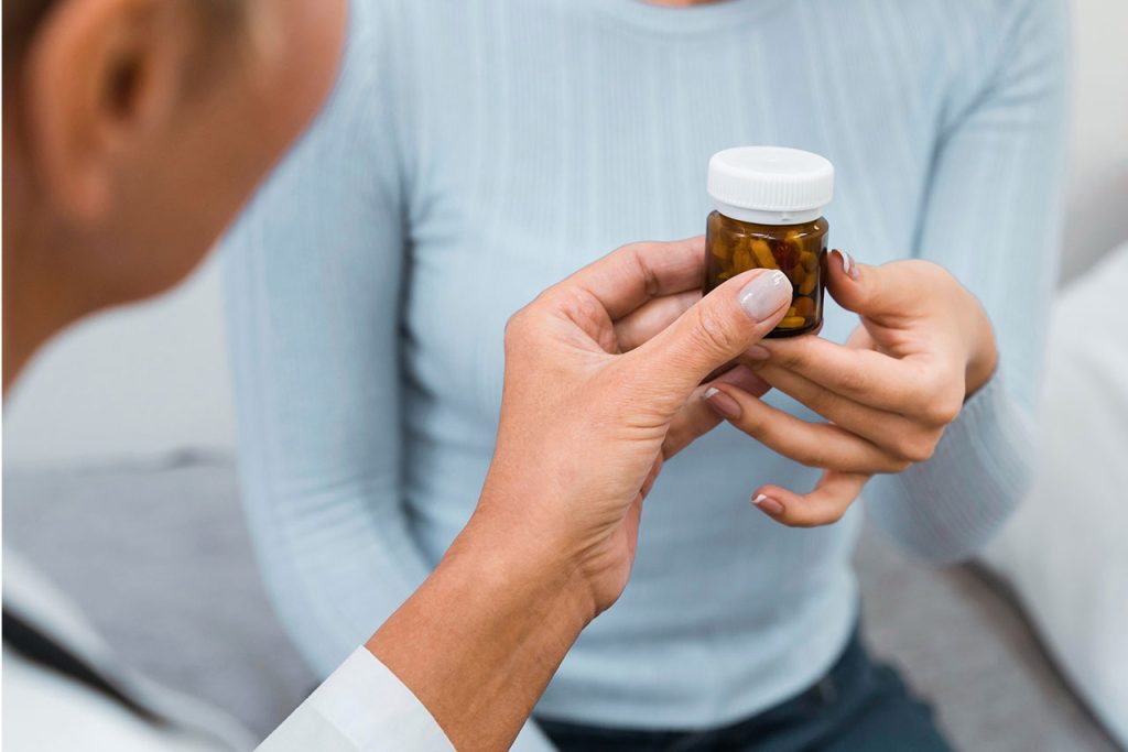 Woman in midlife discussing hormone replacement therapy options with a medical provider