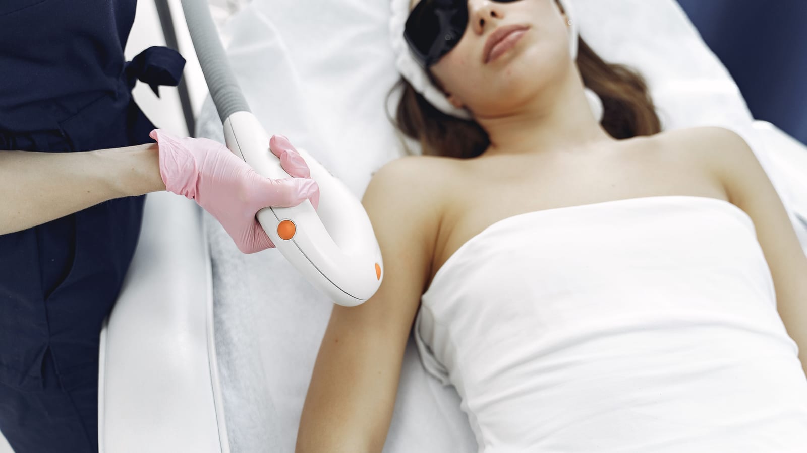 Body-contouring equipment beside a treatment bed in a clinic room — body contouring guide at OC Weight Loss & Med Spa