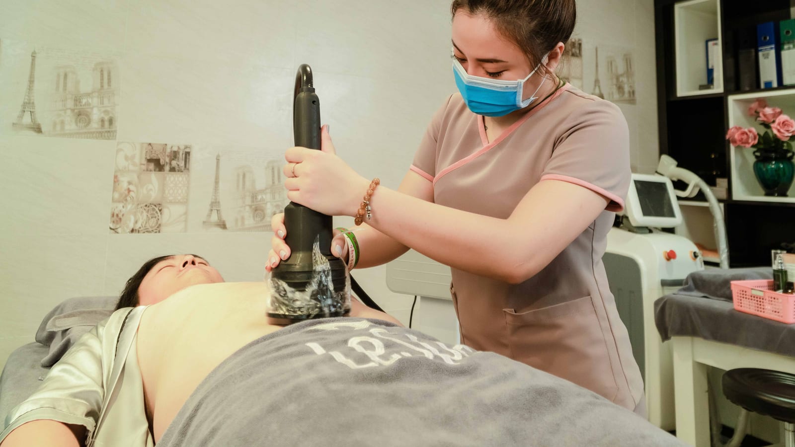 Body-contouring equipment beside a treatment bed in a clinic room — coolsculpting sessions at OC Weight Loss & Med Spa
