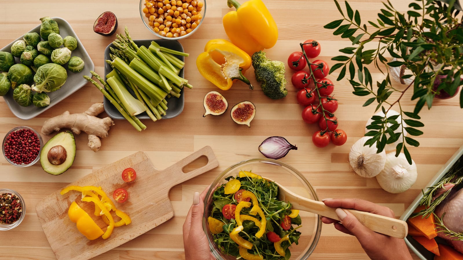 Fresh vegetables and a prepared salad bowl on a wooden table — how to reduce belly fat at OC Weight Loss & Med Spa, Mission