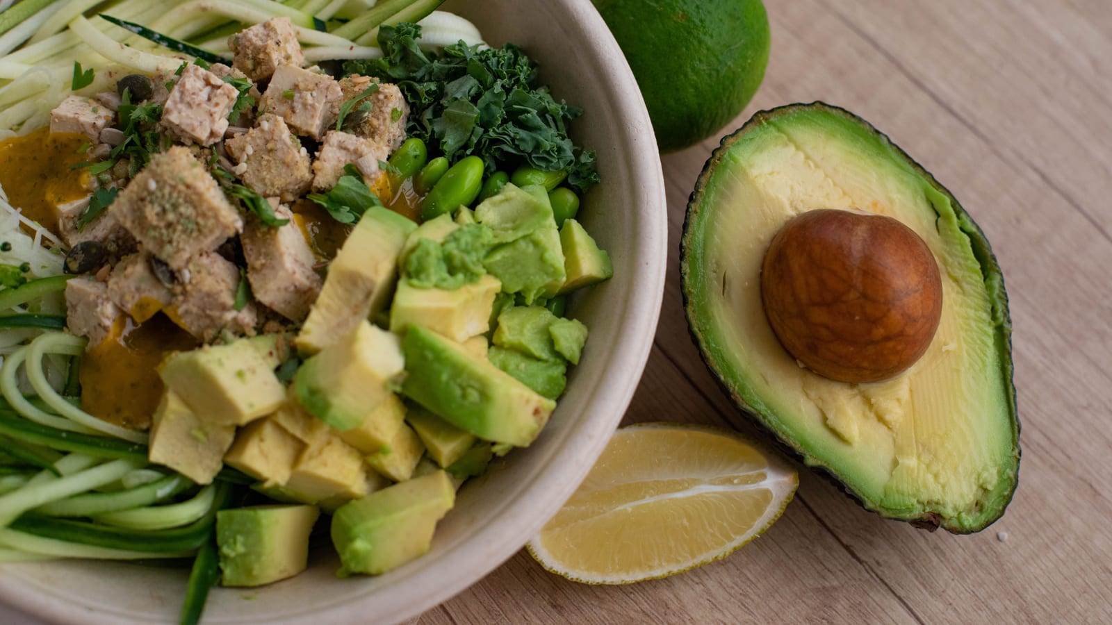 Fresh vegetables and a prepared salad bowl on a wooden table — glp-1 muscle loss prevention at OC Weight Loss & Med Spa