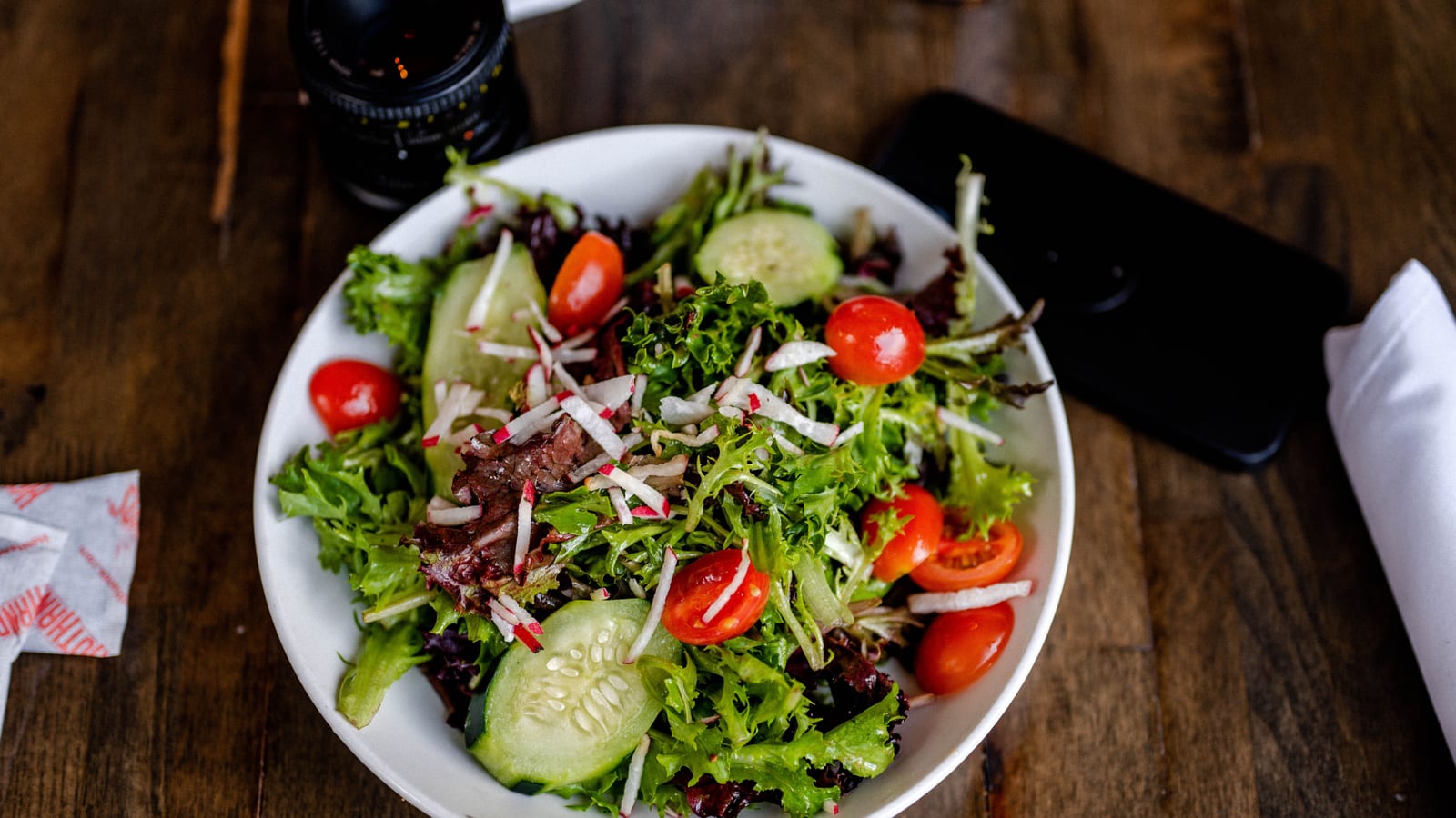 Fresh vegetables and a prepared salad bowl on a wooden table — nutrition counseling benefits & what to expect at OC Weight