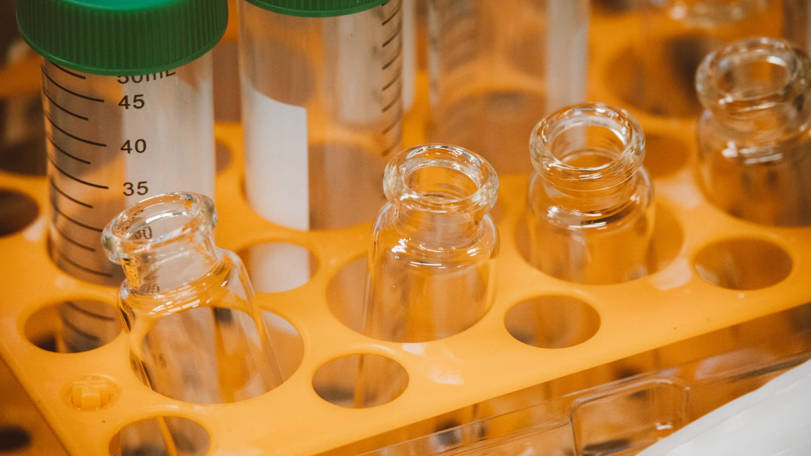 Small glass vials in a tray on a clean counter — nad+ iv vs injection at OC Weight Loss & Med Spa, Mission Viejo