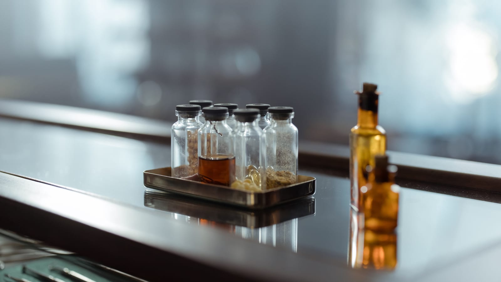 Small glass vials in a tray on a clean counter — peptide therapy in laguna niguel at OC Weight Loss & Med Spa, Mission Viejo