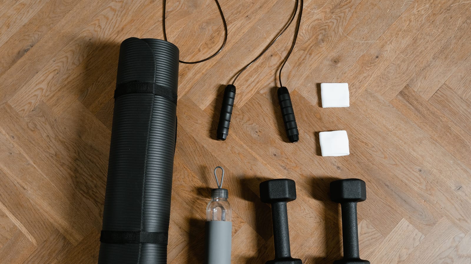 Exercise mat, dumbbell and folded towel in a bright, minimal room — signs your workout isn't working — what to do instead at