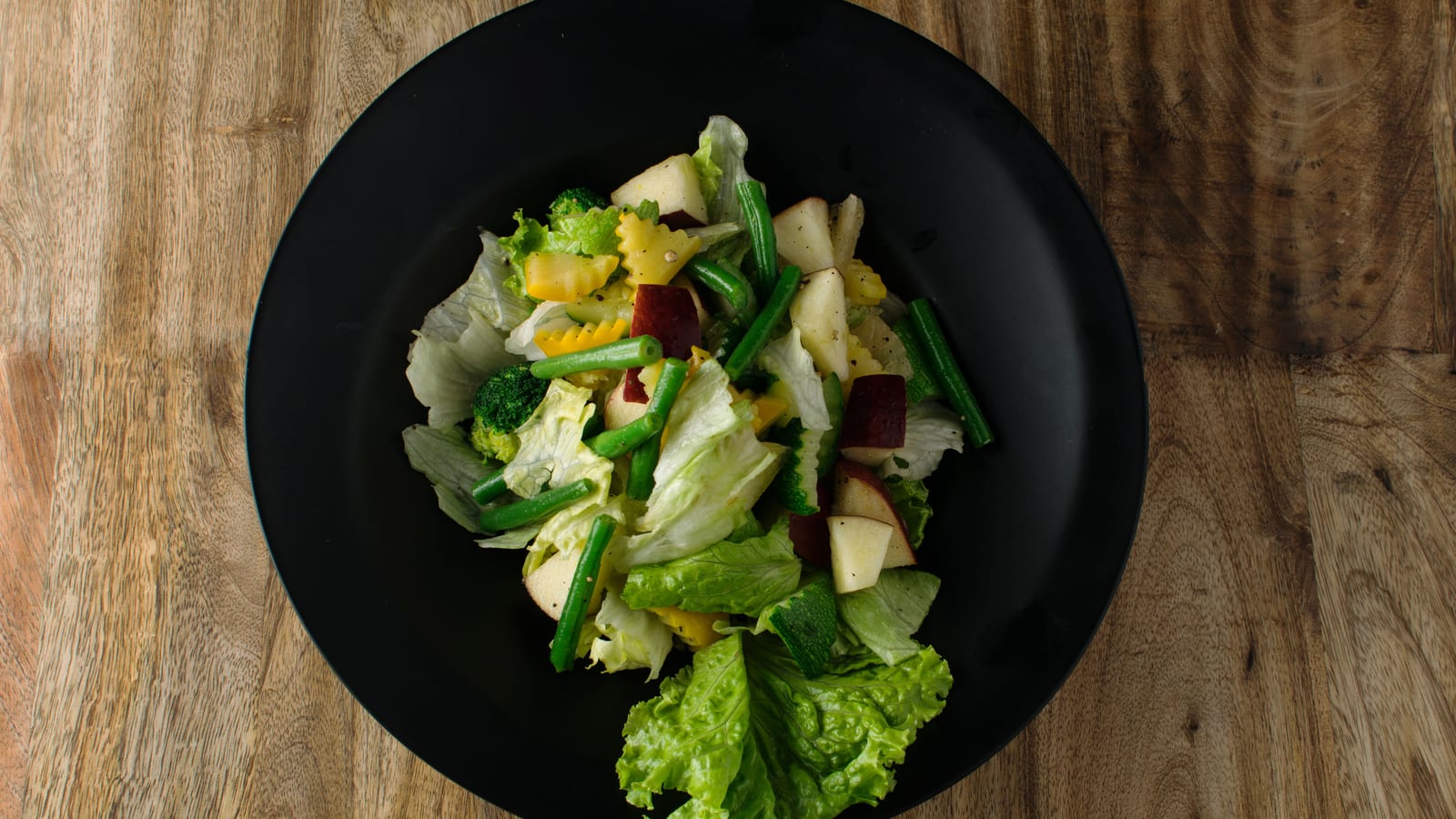Fresh vegetables and a prepared salad bowl on a wooden table — what to eat on mounjaro at OC Weight Loss & Med Spa, Mission