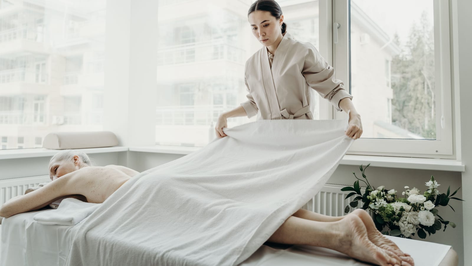 Serene med spa treatment room with a linen-draped bed and a large window — health benefits of losing weight at OC Weight